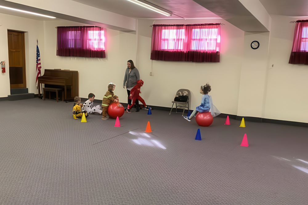 A vibrant scene of children playing with balls in a room, capturing the essence of fun and playtime, rain or shine.