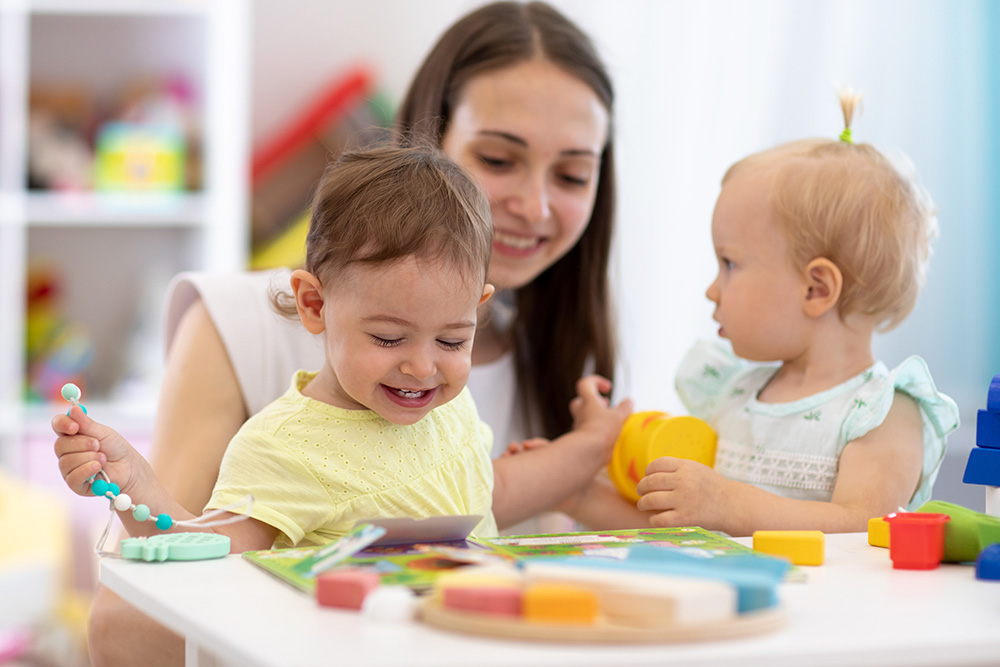 A woman and two children joyfully engage in play with colorful toys, embodying active exploration and creativity.