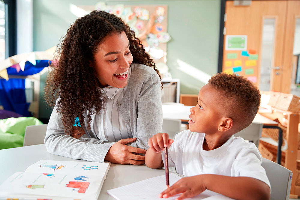 A woman and child share a moment at a table, reading a book, emphasizing personalized homework support.